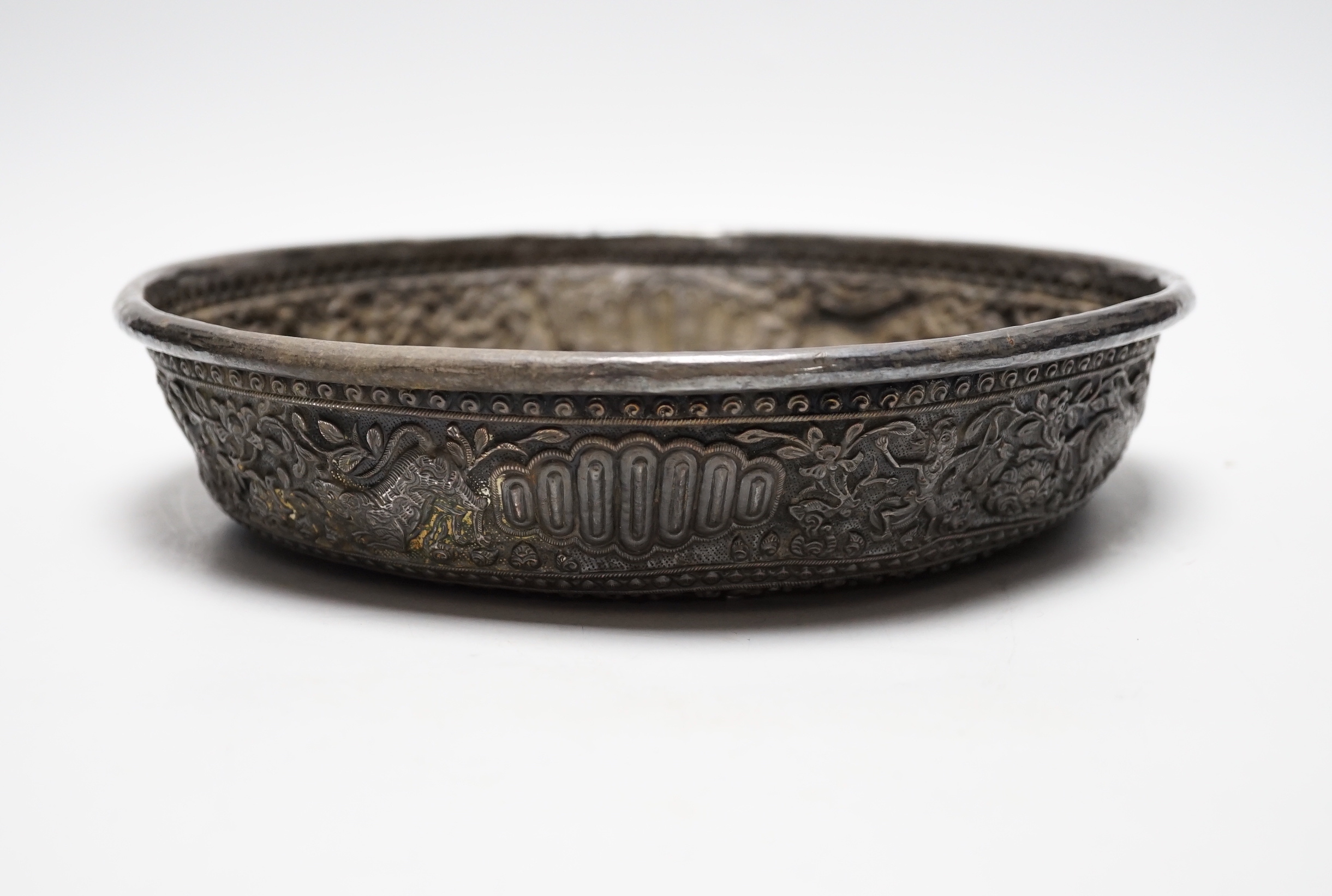 An Asian embossed white metal (tests as silver) shallow bowl, 25.2cm, 13.5oz.